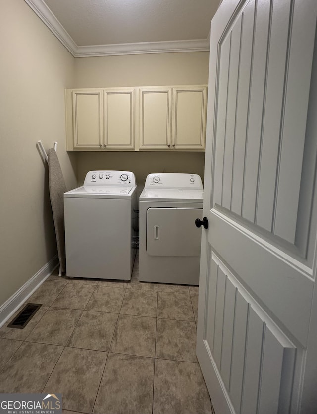 306 Reserve Ln, Saint Simons, GA 31522 - laundry room with crown molding, cabinet space, washer and dryer, light tile patterned flooring, and baseboards