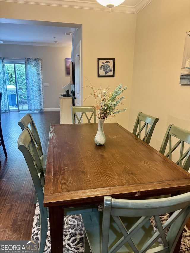 306 Reserve Ln, Saint Simons, GA 31522 - dining space featuring dark wood finished floors, ornamental molding, and baseboards