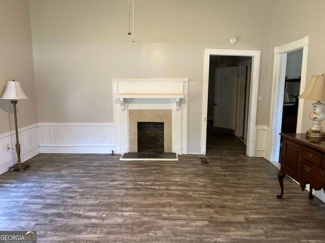 243 Old Acworth Rd, Dallas, GA 30132 - unfurnished living room featuring wood finished floors, a wainscoted wall, and a tiled fireplace
