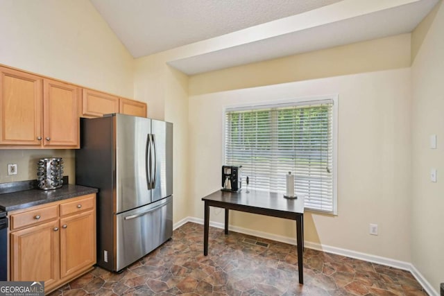 3705 Tate Pl, Austell, GA 30106 - kitchen with freestanding refrigerator, dark countertops, dark stone finish floors, and lofted ceiling