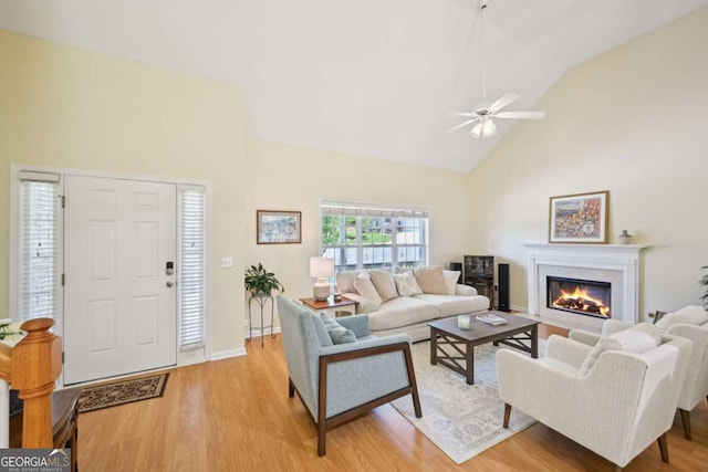 3705 Tate Pl, Austell, GA 30106 - living area featuring high vaulted ceiling, light wood finished floors, a fireplace with flush hearth, and ceiling fan