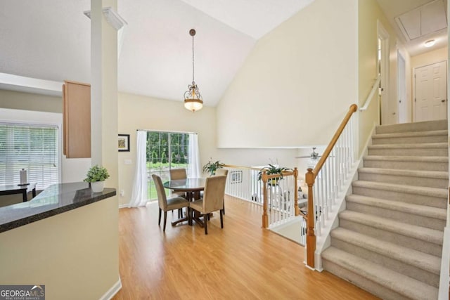 3705 Tate Pl, Austell, GA 30106 - dining room with high vaulted ceiling, light wood finished floors, attic access, stairs, and ceiling fan