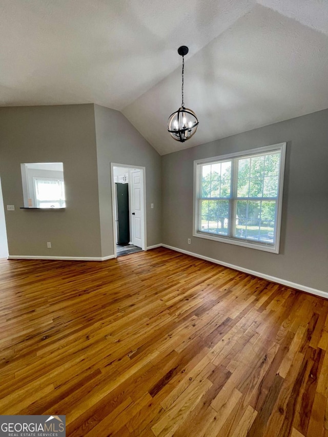 350 Fall View Ct, Winder, GA 30680 - unfurnished room with a chandelier, wood-type flooring, and lofted ceiling