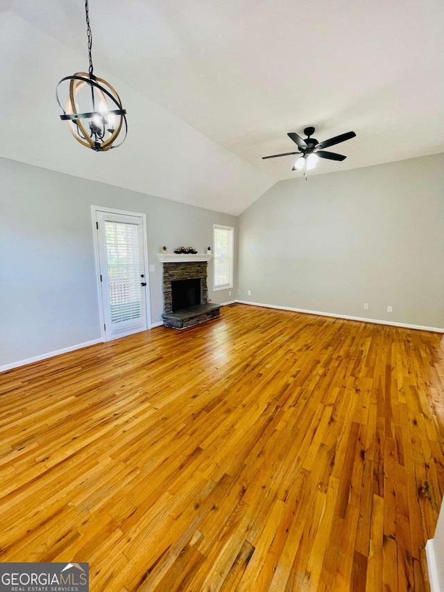 350 Fall View Ct, Winder, GA 30680 - unfurnished living room featuring light wood finished floors, lofted ceiling, a chandelier, ceiling fan, and healthy amount of natural light