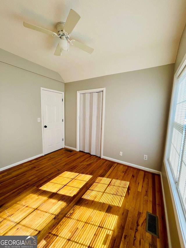 350 Fall View Ct, Winder, GA 30680 - unfurnished bedroom with lofted ceiling, wood finished floors, a closet, and a ceiling fan