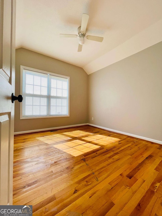 350 Fall View Ct, Winder, GA 30680 - spare room with vaulted ceiling, wood-type flooring, and ceiling fan