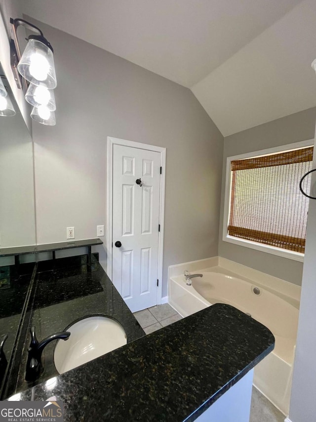 350 Fall View Ct, Winder, GA 30680 - bathroom featuring a bath, lofted ceiling, tile patterned floors, and vanity