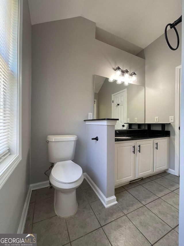 350 Fall View Ct, Winder, GA 30680 - bathroom featuring lofted ceiling, vanity, tile patterned flooring, and plenty of natural light