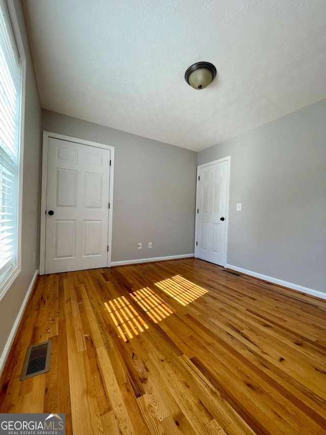 350 Fall View Ct, Winder, GA 30680 - empty room with light wood finished floors and a textured ceiling