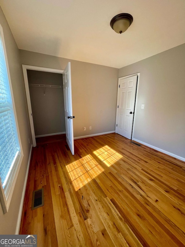 350 Fall View Ct, Winder, GA 30680 - unfurnished bedroom featuring hardwood / wood-style flooring and a closet