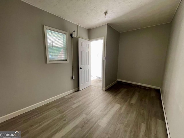 350 Fall View Ct, Winder, GA 30680 - empty room featuring wood finished floors and a textured ceiling