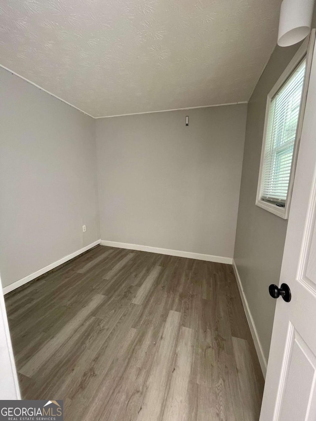 350 Fall View Ct, Winder, GA 30680 - empty room with wood finished floors and a textured ceiling