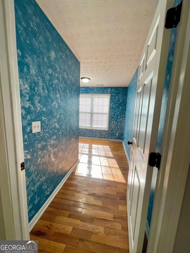 350 Fall View Ct, Winder, GA 30680 - hallway with wallpapered walls, hardwood / wood-style floors, and a textured ceiling
