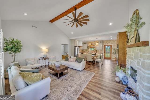 1354 Lakeway Rd, East Dublin, GA 31027 - living area with beamed ceiling, light wood-style floors, a fireplace, high vaulted ceiling, and recessed lighting
