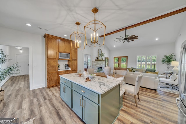 1354 Lakeway Rd, East Dublin, GA 31027 - kitchen featuring stainless steel microwave, light wood-type flooring, recessed lighting, a fireplace, and a kitchen island