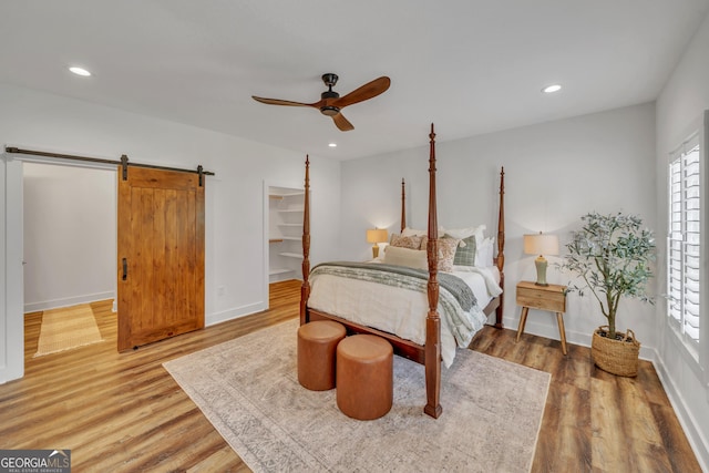 1354 Lakeway Rd, East Dublin, GA 31027 - bedroom with multiple windows, a barn door, wood finished floors, and recessed lighting