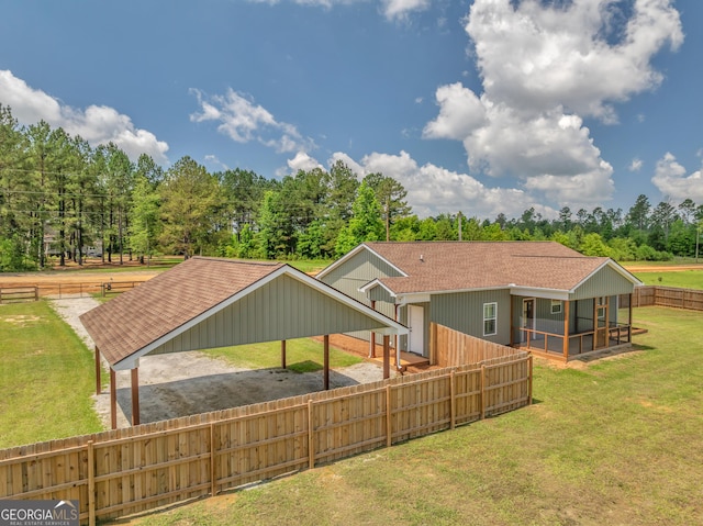 1354 Lakeway Rd, East Dublin, GA 31027 - back of property with a sunroom, a shingled roof, a detached carport, and dirt driveway