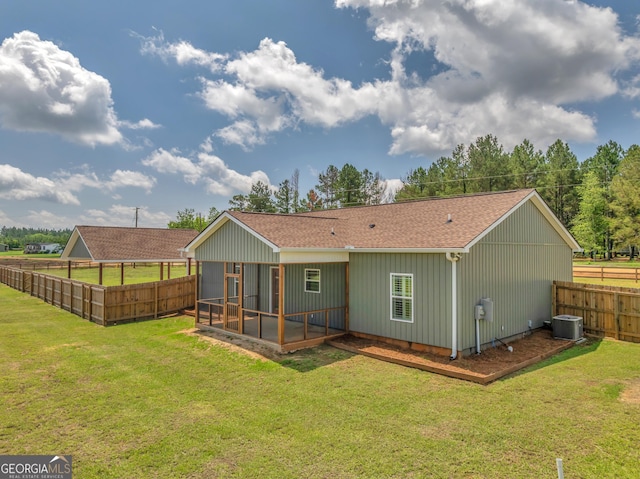 1354 Lakeway Rd, East Dublin, GA 31027 - back of house featuring a sunroom, a shingled roof, and a fenced backyard