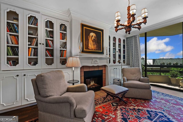 2660 Peachtree Rd Unit 6A, Atlanta, GA 30305 - sitting room with a chandelier, crown molding, a tiled fireplace, and built in shelves