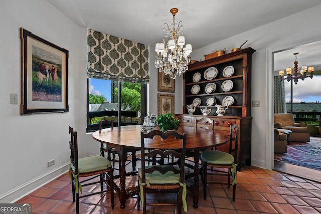 2660 Peachtree Rd Unit 6A, Atlanta, GA 30305 - tiled dining area featuring a chandelier and baseboards