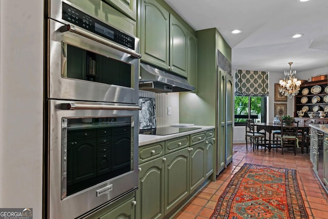 2660 Peachtree Rd Unit 6A, Atlanta, GA 30305 - kitchen featuring green cabinets, stainless steel double oven, under cabinet range hood, a chandelier, and light countertops