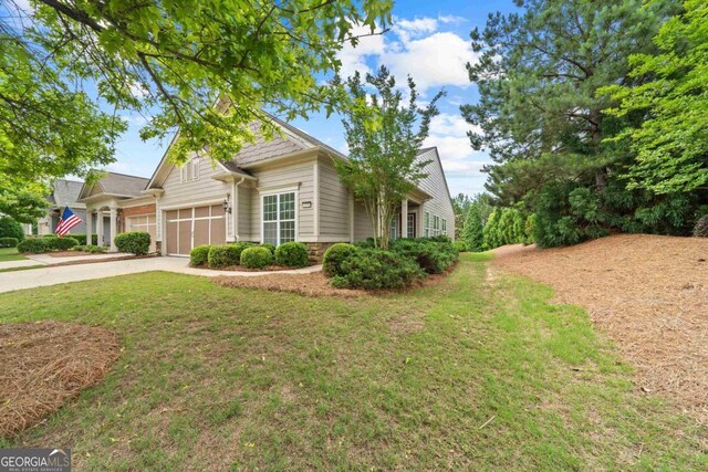 1370 Summer Hollow Rd, Greensboro, GA 30642 - view of front of house featuring concrete driveway, a garage, a front lawn, and stone siding
