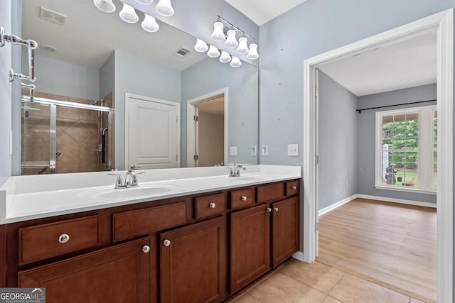 1370 Summer Hollow Rd, Greensboro, GA 30642 - bathroom featuring double vanity, tile patterned flooring, a tile shower, and baseboards