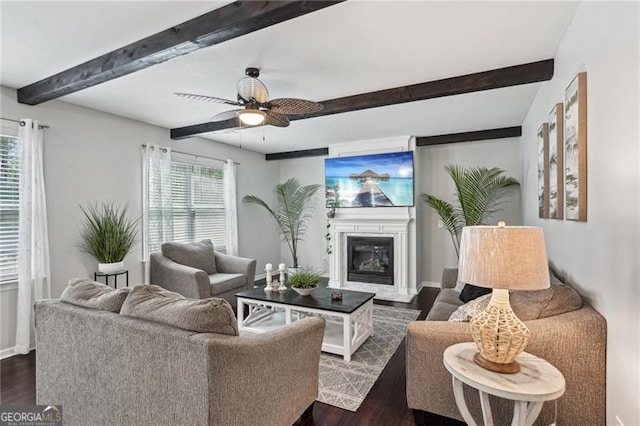 1017 Preserve Park Dr, Loganville, GA 30052 - living room with dark wood-type flooring, beam ceiling, a glass covered fireplace, and a ceiling fan