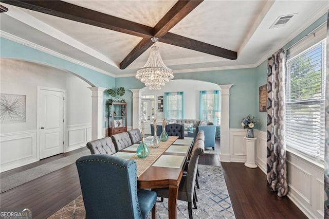 1017 Preserve Park Dr, Loganville, GA 30052 - dining space featuring decorative columns, coffered ceiling, a wainscoted wall, arched walkways, and a decorative wall
