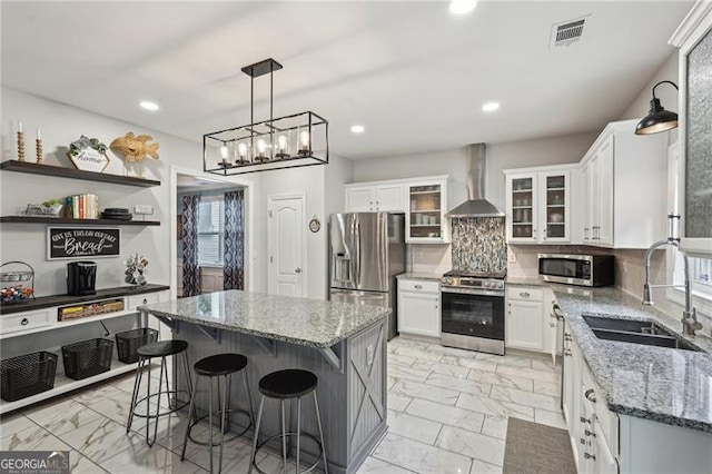 1017 Preserve Park Dr, Loganville, GA 30052 - kitchen with stainless steel appliances, wall chimney range hood, light marble finish floors, light stone countertops, and recessed lighting