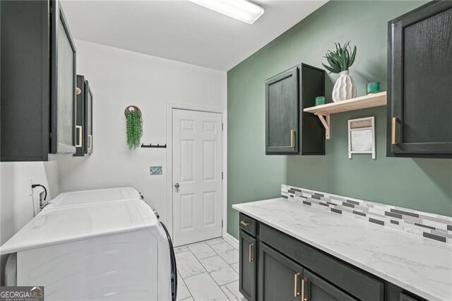 1017 Preserve Park Dr, Loganville, GA 30052 - laundry area featuring cabinet space, independent washer and dryer, and light marble finish floors