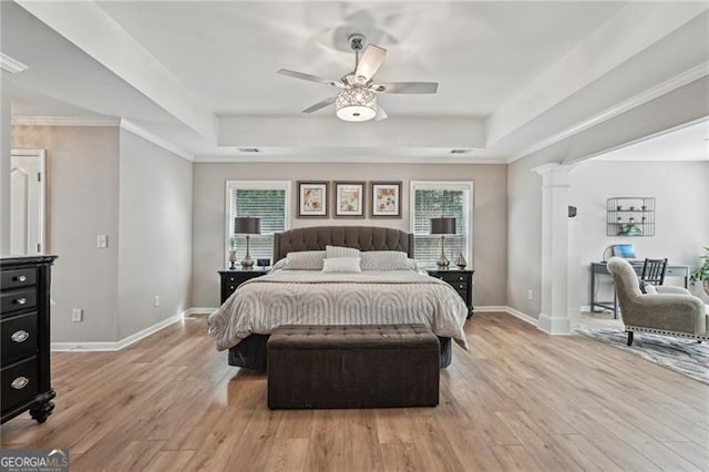 1017 Preserve Park Dr, Loganville, GA 30052 - bedroom with a tray ceiling, light wood finished floors, and a ceiling fan