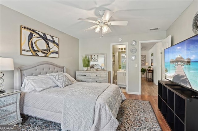 1017 Preserve Park Dr, Loganville, GA 30052 - bedroom featuring wood finished floors, ceiling fan, and ensuite bathroom