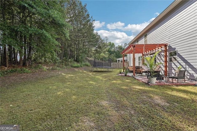 1017 Preserve Park Dr, Loganville, GA 30052 - view of green lawn with a trampoline, a pergola, and a patio area