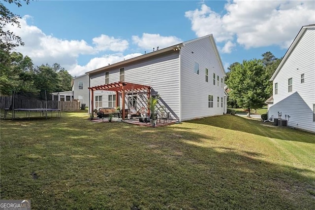 1017 Preserve Park Dr, Loganville, GA 30052 - back of property with a trampoline, a pergola, a patio, and a yard