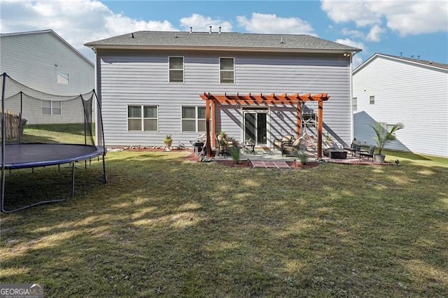 1017 Preserve Park Dr, Loganville, GA 30052 - back of house featuring a trampoline, a pergola, a patio, and a lawn