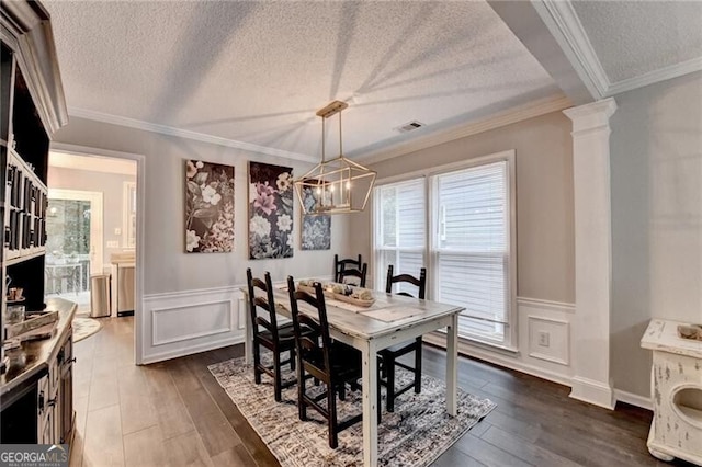 10000 Barston Ct, Johns Creek, GA 30022 - dining space featuring a chandelier, dark wood-type flooring, a textured ceiling, crown molding, and wainscoting