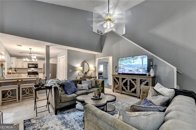 10000 Barston Ct, Johns Creek, GA 30022 - living room with light colored carpet, a high ceiling, a chandelier, and a ceiling fan