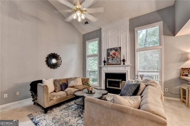 10000 Barston Ct, Johns Creek, GA 30022 - living room with light colored carpet, a ceiling fan, a fireplace, and high vaulted ceiling
