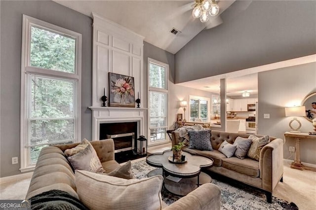 10000 Barston Ct, Johns Creek, GA 30022 - living room featuring light colored carpet, ceiling fan, a large fireplace, and high vaulted ceiling