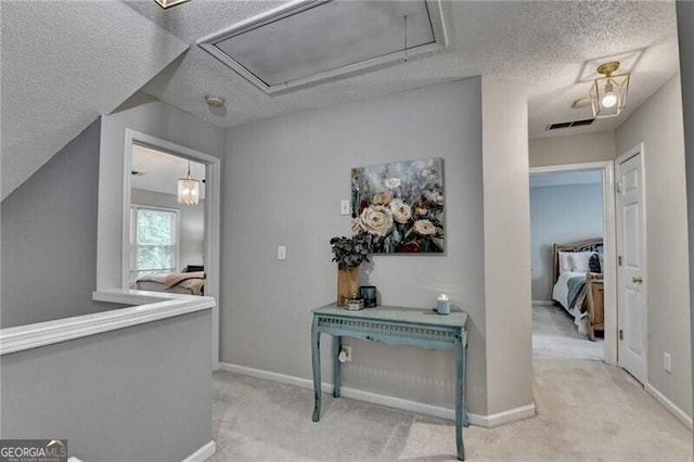10000 Barston Ct, Johns Creek, GA 30022 - hallway featuring attic access, a textured ceiling, and carpet floors