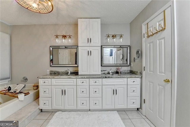 10000 Barston Ct, Johns Creek, GA 30022 - bathroom featuring tile patterned flooring, double vanity, a bath, and a textured ceiling