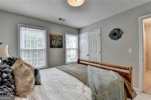 10000 Barston Ct, Johns Creek, GA 30022 - carpeted bedroom featuring a closet and a textured ceiling