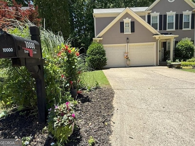 10000 Barston Ct, Johns Creek, GA 30022 - view of front facade with a garage, driveway, and stucco siding