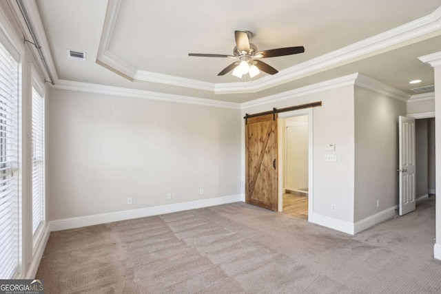 345 Alderwood Ln, Sandy Springs, GA 30328 - unfurnished bedroom featuring carpet, crown molding, a barn door, a raised ceiling, and ceiling fan