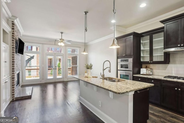 345 Alderwood Ln, Sandy Springs, GA 30328 - kitchen featuring appliances with stainless steel finishes, french doors, a breakfast bar, glass insert cabinets, and decorative backsplash