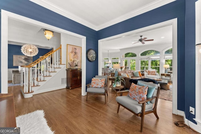 2936 Summitop Rd NE, Marietta, GA 30066 - sitting room with stairway, crown molding, wood finished floors, a ceiling fan, and a chandelier