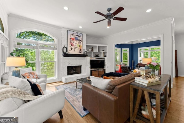 2936 Summitop Rd NE, Marietta, GA 30066 - living room featuring crown molding, light wood-type flooring, a fireplace, ceiling fan, and recessed lighting