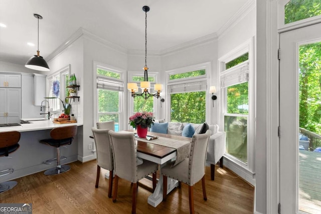 2936 Summitop Rd NE, Marietta, GA 30066 - dining space featuring crown molding, wood finished floors, a chandelier, and baseboards