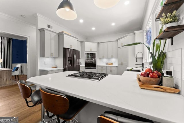 2936 Summitop Rd NE, Marietta, GA 30066 - kitchen with stainless steel appliances, crown molding, a peninsula, a sink, and a breakfast bar area